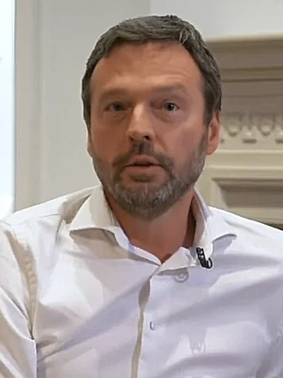 Position de Pierre Wunsch sur les réserves obligatoires — portrait en buste du gouverneur de la Banque nationale de Belgique en chemise blanche.